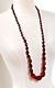 An Antique Graduated And Faceted Cherry Amber Bakelite Necklace Hand Knotting