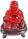 Smiling/laughing Red Amber Buddha With Stand. Approx. 3-11/16 H X 3 1/2 W
