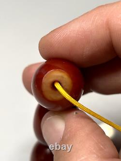 67 grammes de perles en ambre de cerisier Faturan antique en Bakélite marbrée