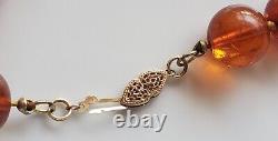 Collier de perles d'ambre vintage de 12mm de longueur 30 pouces qui brille, poids de 65.9 grammes avec fermoir en or 14 carats