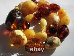 Collier en ambre de la mer Baltique vintage - Perles de grande taille couleur ambrée, caramel, jaune œuf, miel, cognac et cerise.